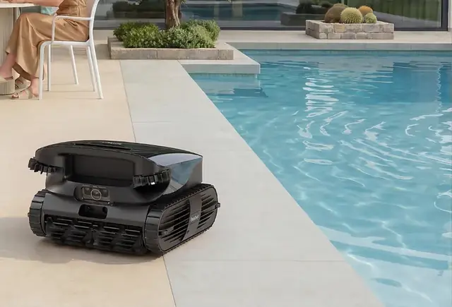 Beatbot AquaSense X robotic pool cleaner beside a backyard pool